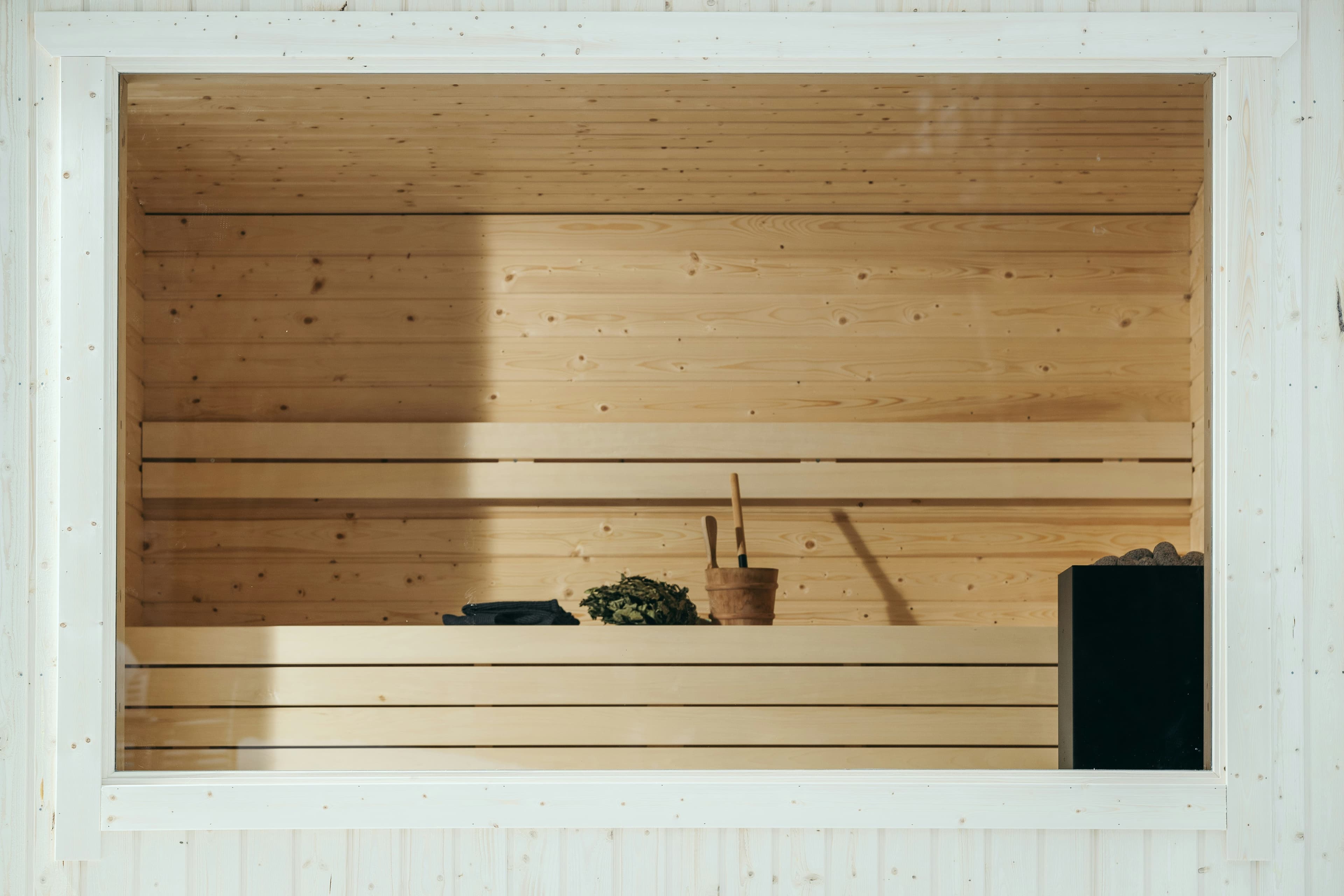 Finnish sauna interior with vihta birch whisk and wooden bucket
